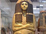 British Museum Top 20 16 Henutmehyt Gilded Outer Coffin 16 Henutmehyt Gilded Outer Coffin - Thebes Egypt, around 1250 BC, 46cm x 187cm. The coffin of Henutmehyt was human-shaped, which was believed to provide the spirit with a substitute body if the mummy should perish. The outer wooden coffin covered with gold leaf provides an idealized image of the dead woman, adorned with her full wig. A collar is spread over the breast, and below it hangs a pectoral (chest) ornament flanked by protective wedjat eyes. The sky-goddess Nut spreads her winged arms protectively across the body, and the hieroglyphic text immediately below invokes her. Vertical and horizontal bands divide the remainder of the lid into compartments which are occupied by figures of the Sons of Horus and the goddesses Isis and Nephthys.